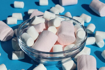 Fototapeta na wymiar There are many different sweet marshmallows in a glass plate.