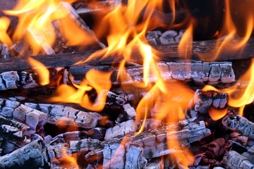 Abstract flame background with bright fire with firewood.