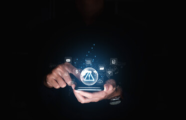 Businessman holding smartphone with caution warning sign for notification error and maintenance concept.