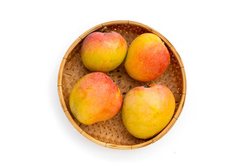 Mango in bamboo basket on white background.Tropical fruit