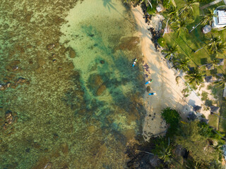 Aerial drone view of beautiful beach with turquoise sea water and palm trees of Gulf of Thailand. Kood island, Thailand.