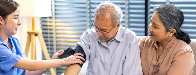 Obraz premium Portrait of smiling caring asian nurse service help support discussing and consulting taking care with senior elderly asian man and woman couple at home visit.senior retirement home care concept