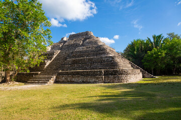 Mayan Ruins in Central American. Chacchobean Mayan ruin site in Mexico view of a large pyramid or temple in an open plaza