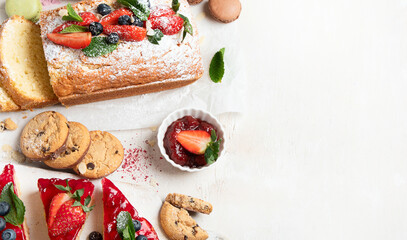 Table with various cookies, cakes and fruits. Delicious dessert table.