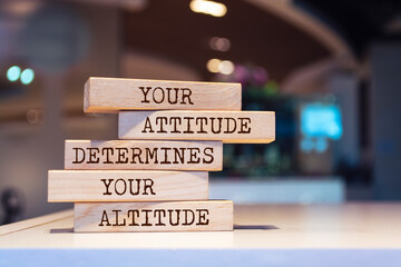 Wooden blocks with words 'Your attitude determines your altitude'.