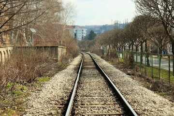 Fototapeta na wymiar Single-track railway on the outskirts of the city