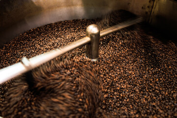 fresh coffee beans roasted spinning cover professional machine close up to soft focus  slow shutter speed because want to make motion blur of coffee beans detail concept, 