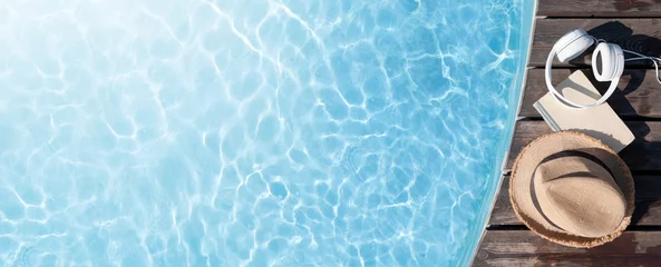 Foto op Plexiglas Spa Book and headphones near swimming pool