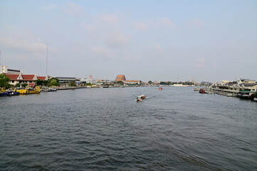 BANGKOK, THAILAND - May 06, 2023 : Tourist Passenger Boat leading tourists to view the houses along the canal and the ways of villagers along the canal in the Chao Phraya River Canal.