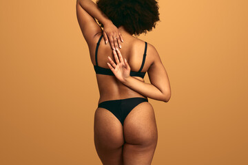 Crop plump black woman stretching arms behind back Generative AI - obrazy, fototapety, plakaty