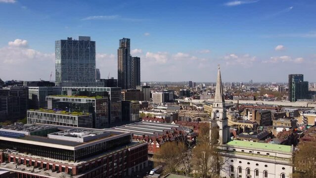 Drone shot historic church and glass skyscrapers in Spitalfields London