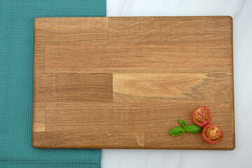Tomato and basil on a wooden board with copy space