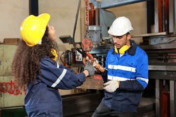 Teamwork technician engineer or worker in protective uniform with safety hardhat standing and...