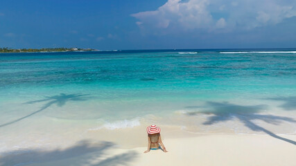 Summer and Relaxing lifestyle young woman lying and sunbathing on the beach