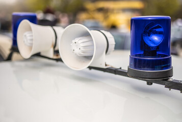 Two loudspeaker and blue lights on top of police car © Zsolt Biczó