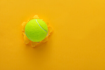 tennis ball on torn paper