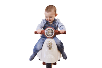 Happy baby boy rides a plastic children motorcycle in the playroom, isolated on a white background. A smiling child drives a moped toy, isolated on a white background. Kid age one year