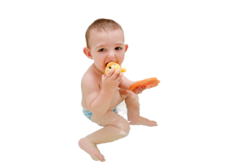 Sad toddler baby boy is playing with toys in the bathtub, isolated on a white background. A child plays in the water of a home bathroom