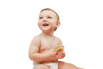 Portrait of a happy toddler baby with a comb in the bathroom by the mirror, isolated on a white background. Baby boy sitting on a towel, isolated on a white background. Kid age one year
