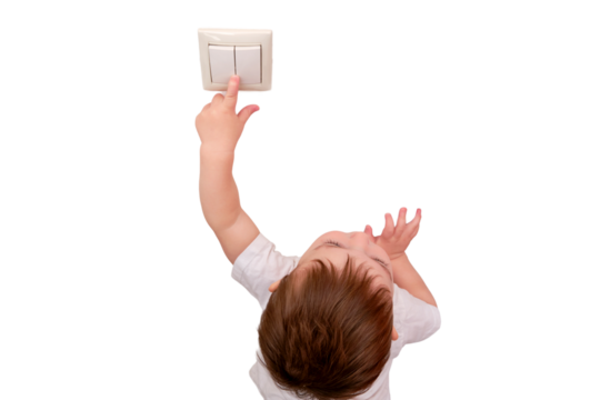 Toddler baby reaches for the light switch, child hand turns on the lamp close-up, isolated on a white background. White light switch in home room and baby hand