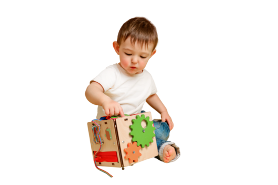 Toddler baby is playing logic educational games busyboard on a studio isolated on a white background. Happy child play with educational toy, learning logic. Kid aged one year four months