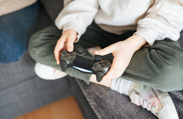 Little girl playing on games console