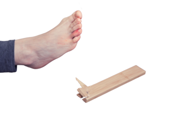 Young woman injured her foot due to falling from a broken chair, isolated on a white background