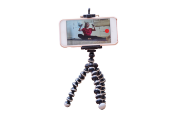 Woman blogging with dumbbells shoots video on the phone camera for a lesson on the Internet, isolated on a white background