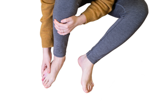 A woman fell from a wooden stepladder and holds on to her sore leg, isolated on a white background. Ladder made of wood broke under a man while working at home