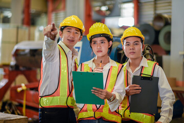 Factory apprenticeship. Header mentor teaching young employees trainee operating machine looking monitor and check Production process machinery. foreman explaining team engineer control machine