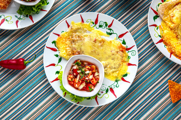 Traditional mexican food. Two enchiladas with beef, beans and cheese. Colorful Food Table Celebration Delicious Party Meal Concept. 
