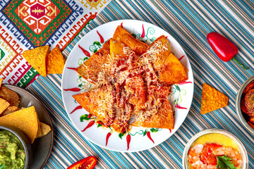 Traditional mexican food. Nachos with chicken and cheese. Colorful Food Table Celebration Delicious Party Meal Concept. 