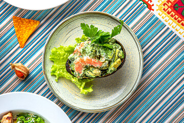 Traditional mexican food. Avocado with shrimp. Colorful Food Table Celebration Delicious Party Meal Concept. 