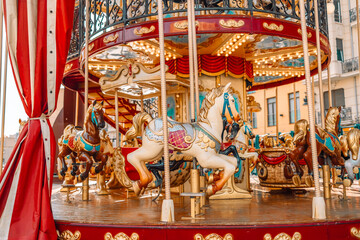 Old carousel in the park. Three horses and a plane on a traditional fair carousel. Carousel with horses in Barcelona, ​​Spain - obrazy, fototapety, plakaty