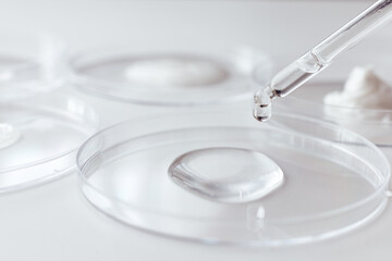 Pipette with Sample of Gels Cosmetic Product in Petri Dish on white background