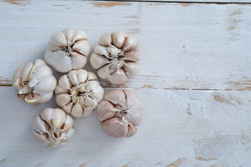 Allium sativum. whole piece of garlic on a white wooden table. Garlic is a cooking spice