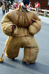 Swiss folklore event, man disguised as Tschäggättä, traditional Valasian frightening figure,...