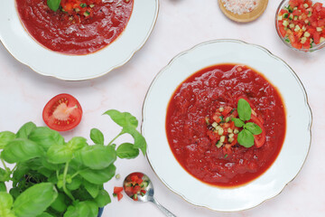 Plates with traditional gazpacho tomato soup