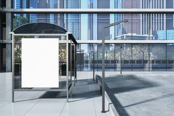 Modern bus stop with empty white mock up banner in creative city with glass buildings and...