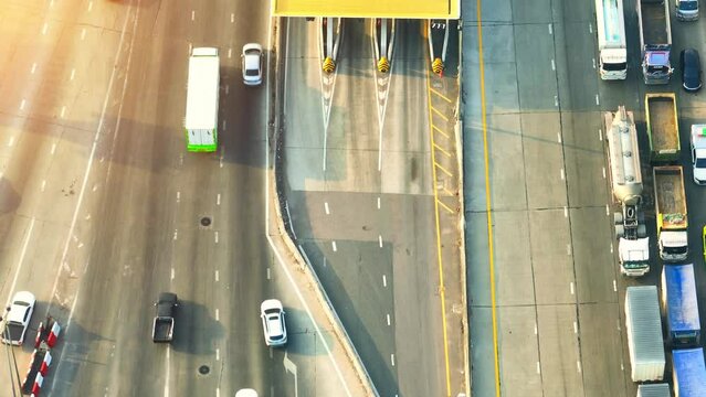 Toll gates are strategically positioned along highways to generate revenue for the maintenance and improvement of the roads. They are often placed at entry or exit points of major cities. Drone. 4K
