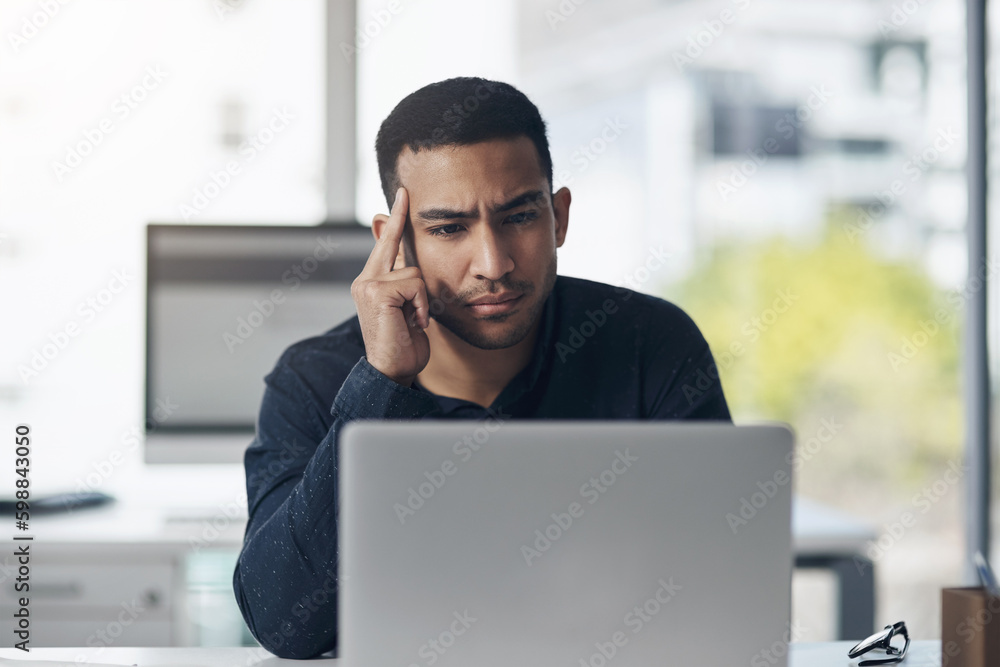 Aufkleber thinking of the best response to this email. a handsome young businessman sitting alone in his offic