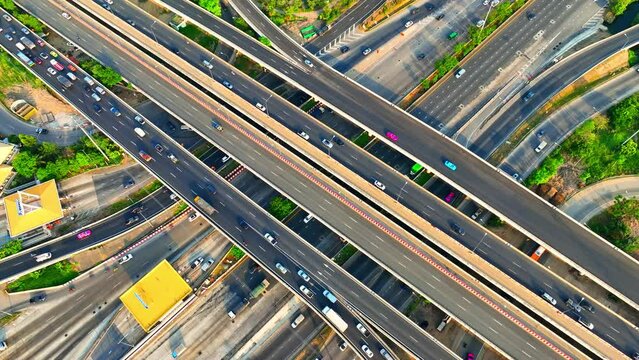 Highway traffic plays a vital role in transportation, allowing people to commute between cities and facilitating the movement of goods and services. Vehicle and traffic concept. Aerial view. Drone
