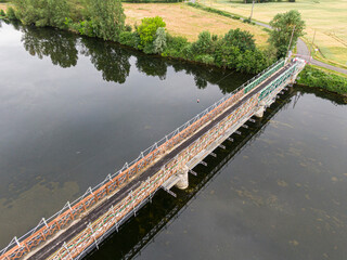 Fototapeta na wymiar Scaffolding used for maintenance or restoration work on a small bridge over a large river the Cher