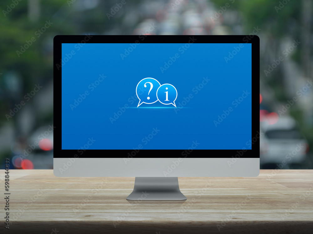 Aufkleber question mark and information chat icon on modern computer monitor screen on wooden table over blur 