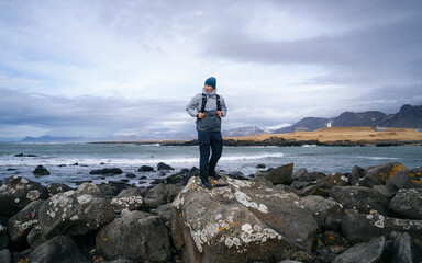 Tourist with a backpack against the sea, panorama. Portrait of a man in tourist gear against the sea. Travel and active lifestyle concept. Portrait of a traveler