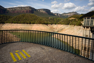 Sau, Spain - 28 April 2023: The dam of the Sau reservoir is seen as the drought caused by climate change causes water shortages in Spain and Europe.