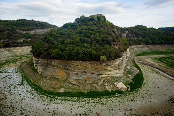 Sau, Spain - 28 April 2023: The Ter river is seen before the Sau reservoir as the drought caused by climate change causes water shortages in Spain and Europe. - obrazy, fototapety, plakaty