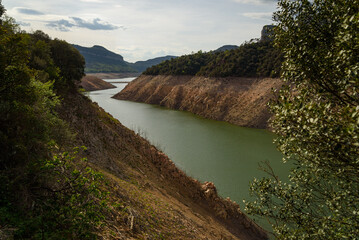 Sau, Spain - 28 April 2023: The almost empty Sau reservoir is seen as the drought caused by climate change causes water shortages in Spain and Europe.