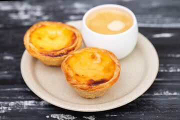 Egg tart, traditional Portuguese dessert, pastel de nata and coffee