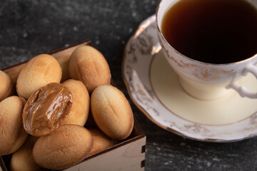 photo of nuts with condensed milk and a cup of coffee